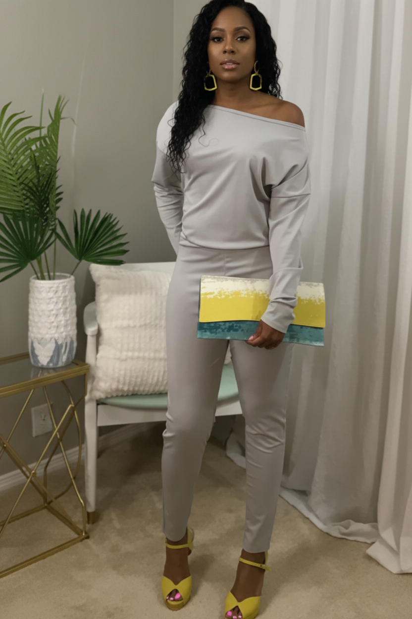 Person wearing a light gray outfit with yellow shoes in a room setting.