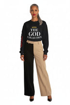 Woman wearing a black sweatshirt with 'The God Collection' text on a white background